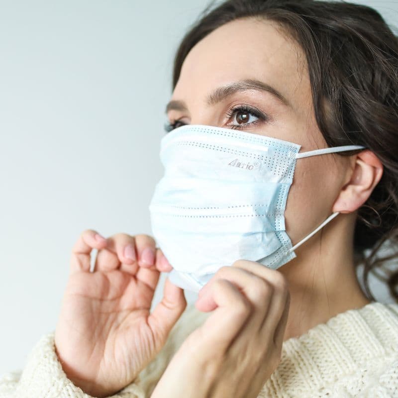 Person wearing a mask during a cold or fever
